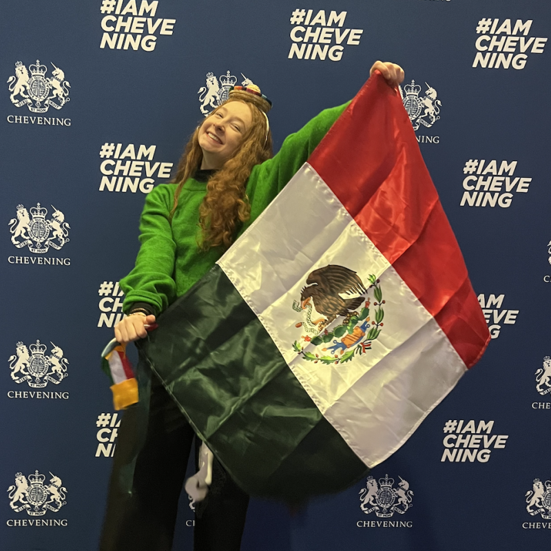 Image of Dalia Grinberg holding the Mexican flag