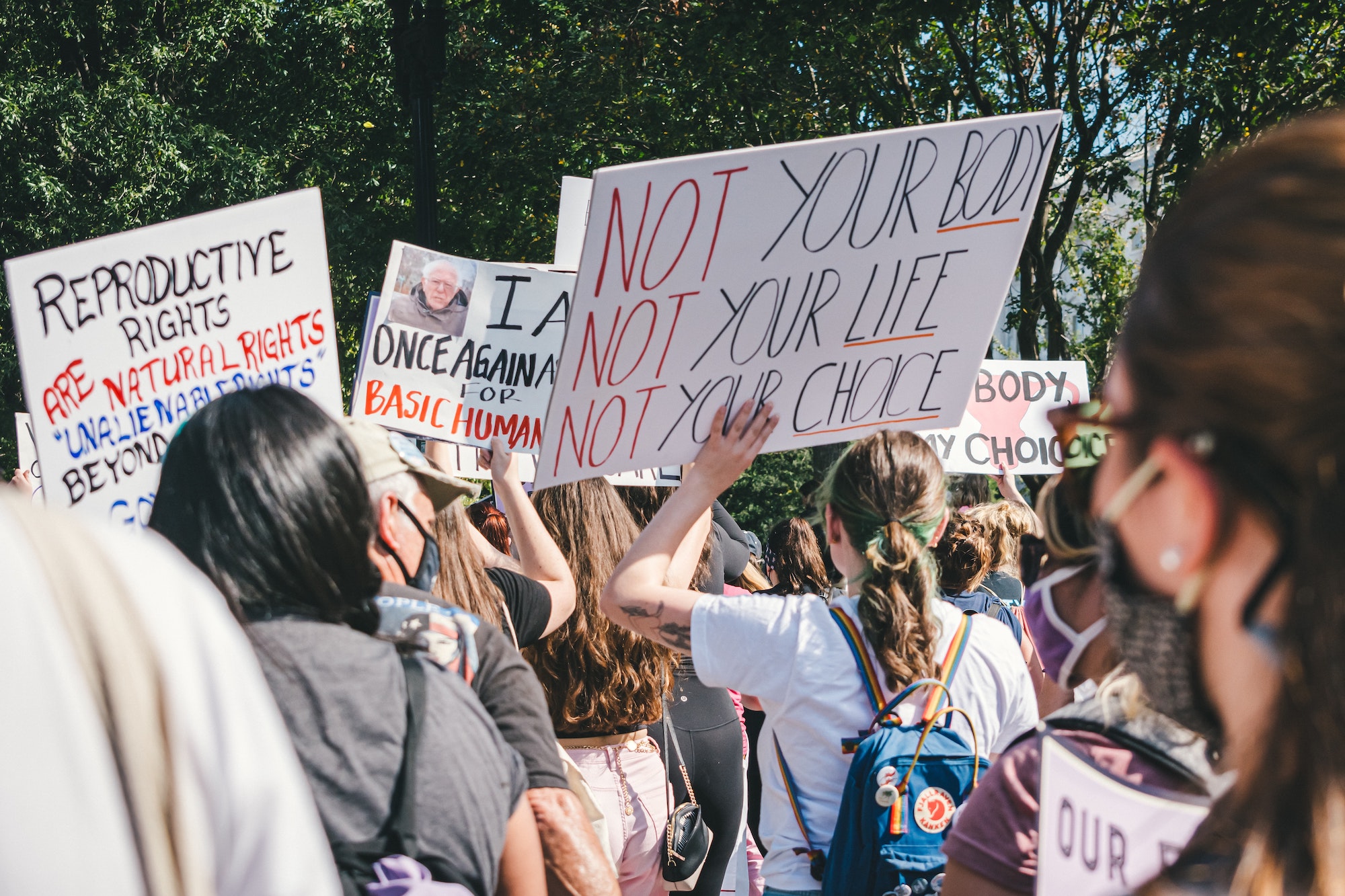 Women holding pro-choice signs at an abortion protest