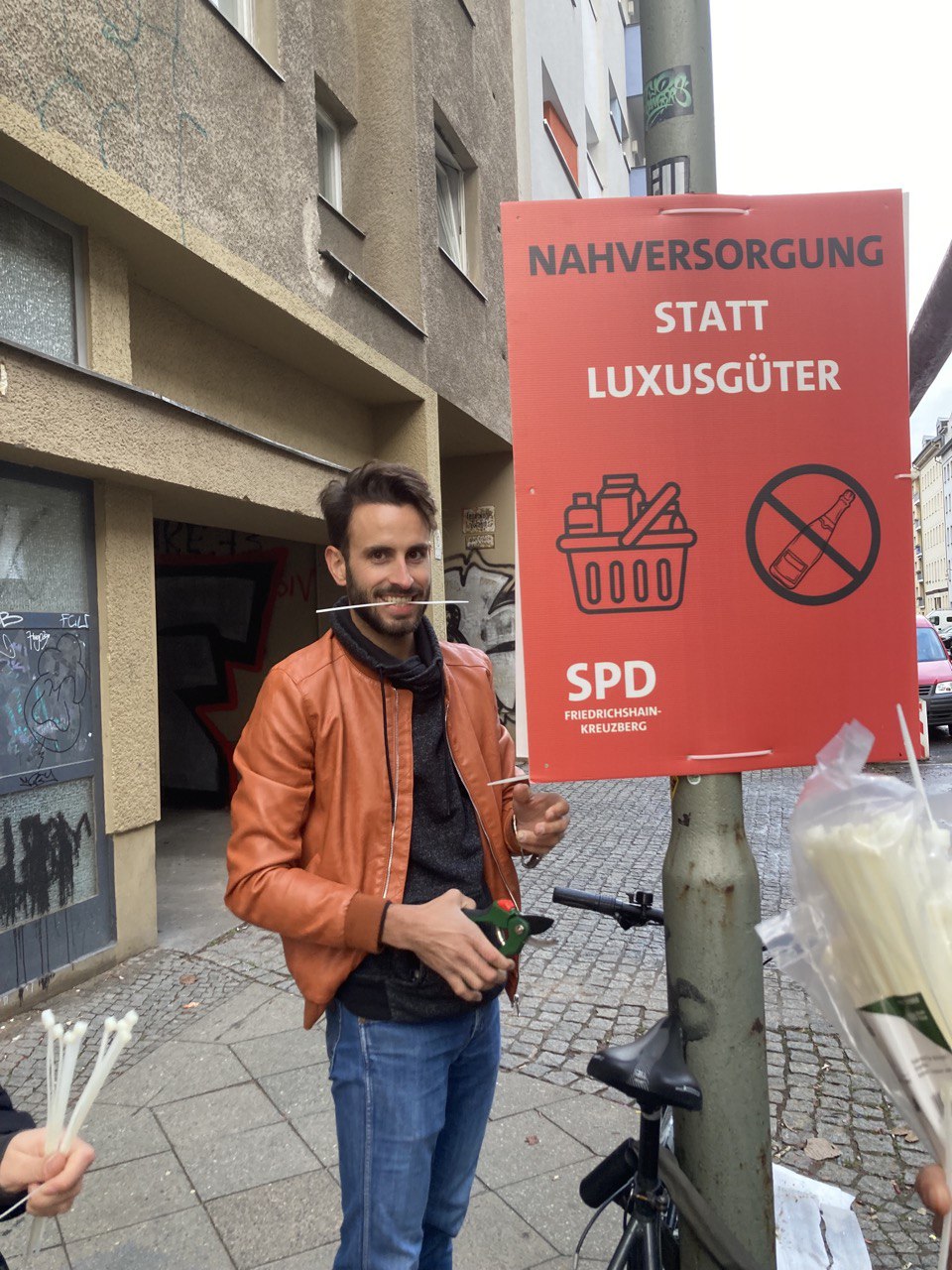 Vincent Wolff stands with SPD election campaign poster