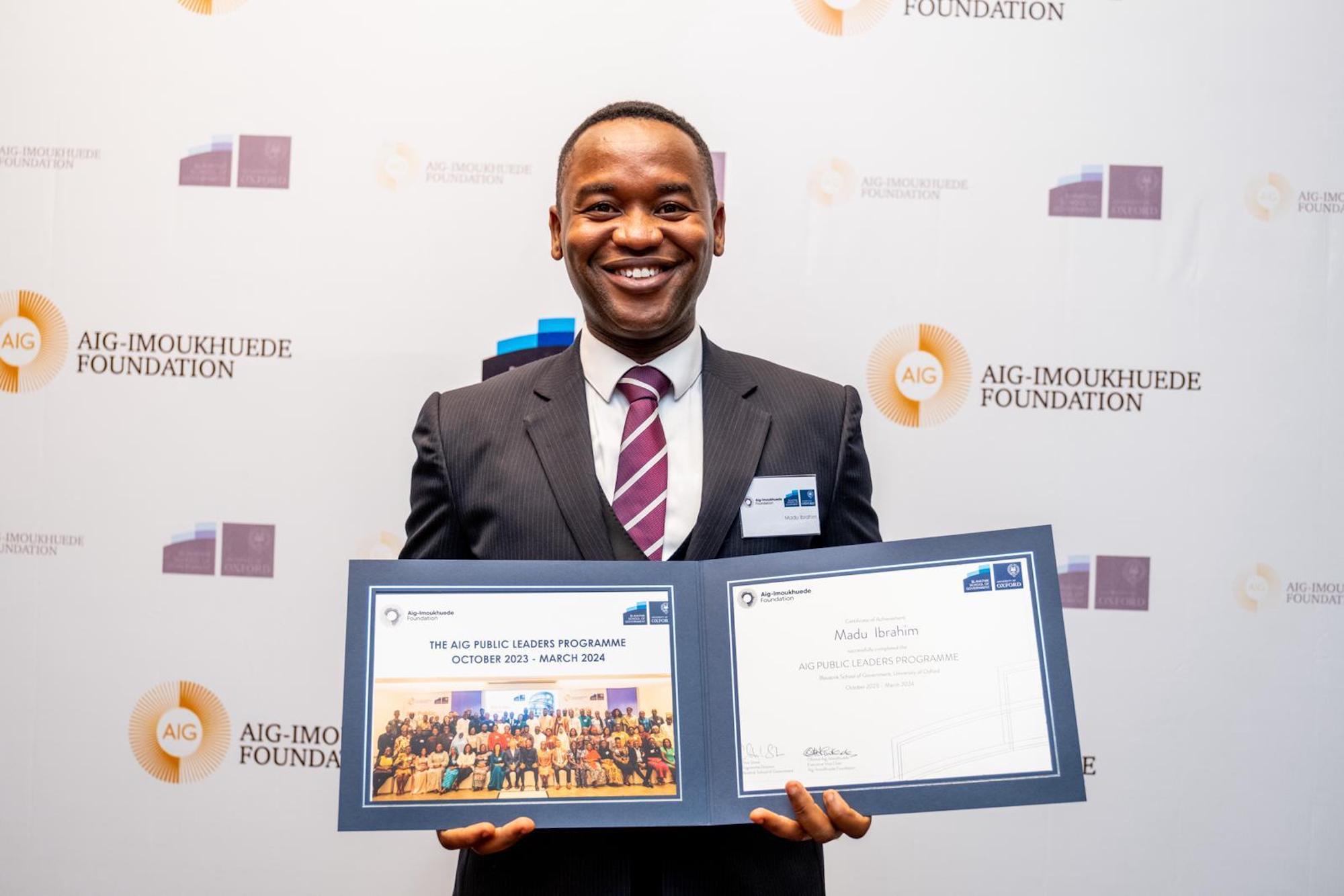 Madu Ibrahim with his AIG certificate