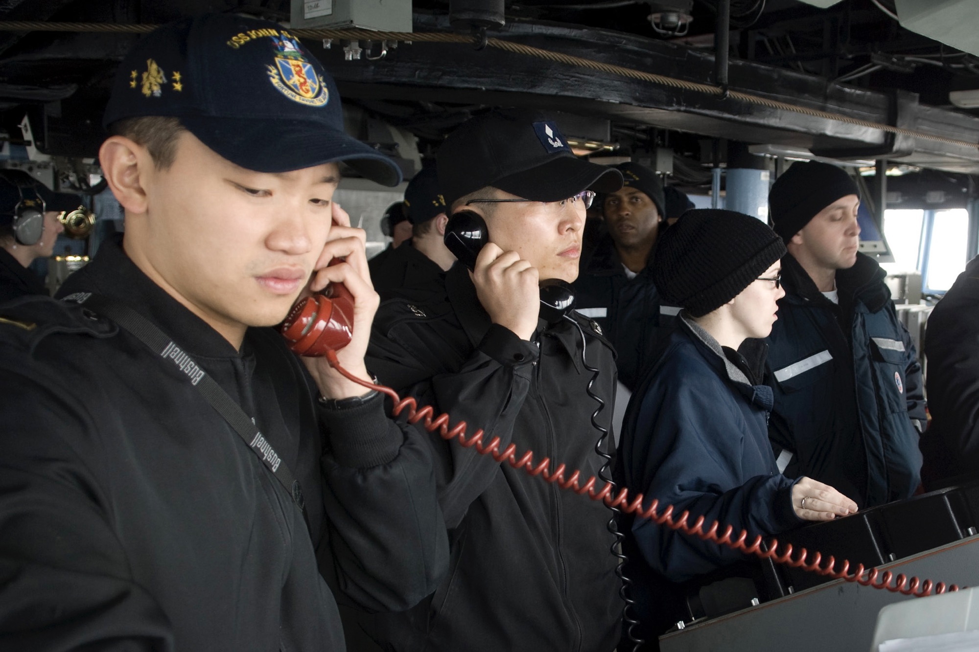 PACIFIC OCEAN (March 18, 2009) Ensign Allan Aw and Republic of Korea Navy Ensign Do-Hee Jung conduct communications between the guided-missile destroyer USS John S. McCain (DDG 56) and the Republic of Korea Navy oiler Hwachon (AOE 59) during an underway replenishment. McCain, one of seven Arleigh Burke-class destroyers assigned to Destroyer Squadron (DESRON) 15, is underway supporting Exercise Foal Eagle 09, a joint exercise between the U.S. and Republic of Korea naval services. (U.S. Navy photo)