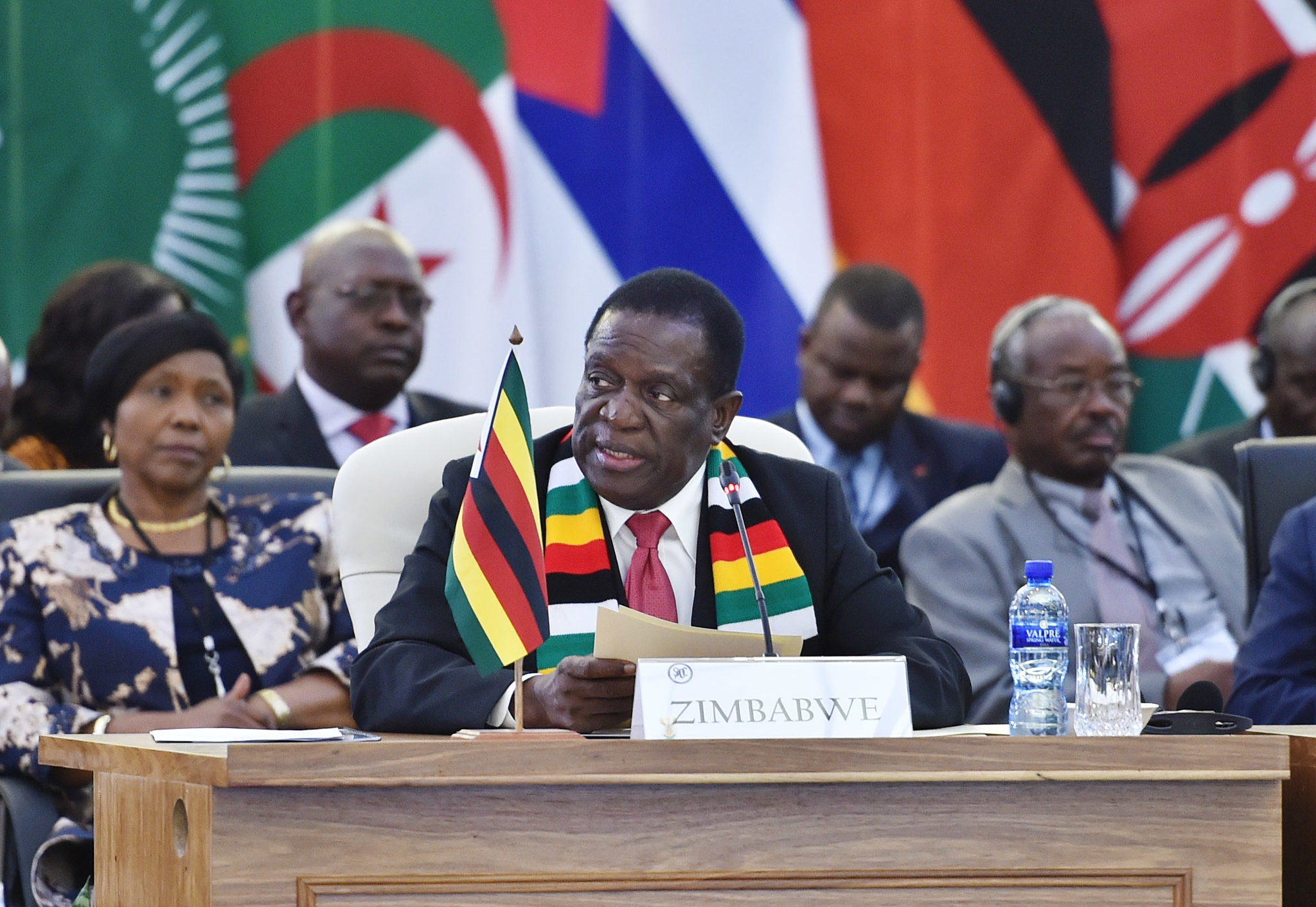 President Emmerson Mnangagwa of Zimbabwe speaking at a podium during the SADC Solidarity Conference, with flags in the background.