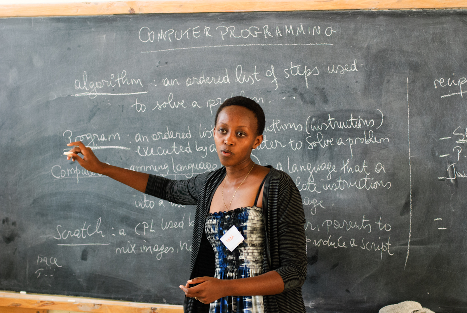 A teacher in front of a blackboard in Rwanda