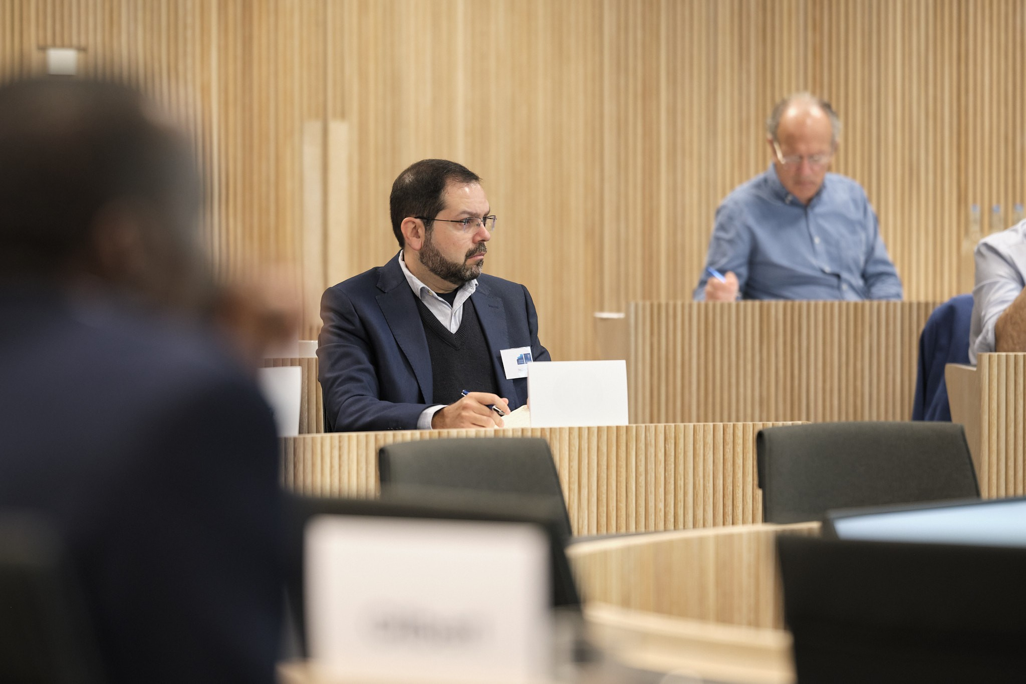 A university classroom with people concentrating