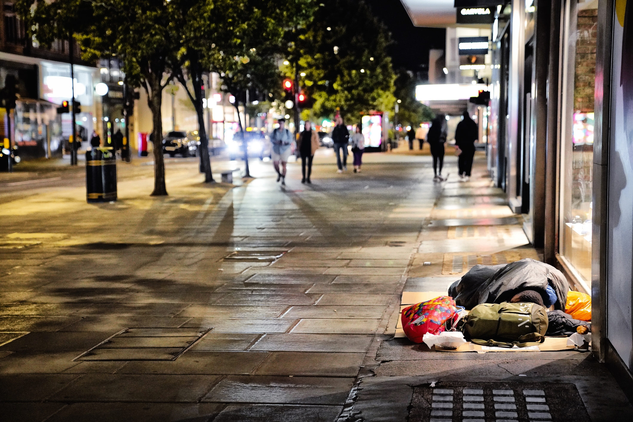 A homeless person sleeps on the street in London