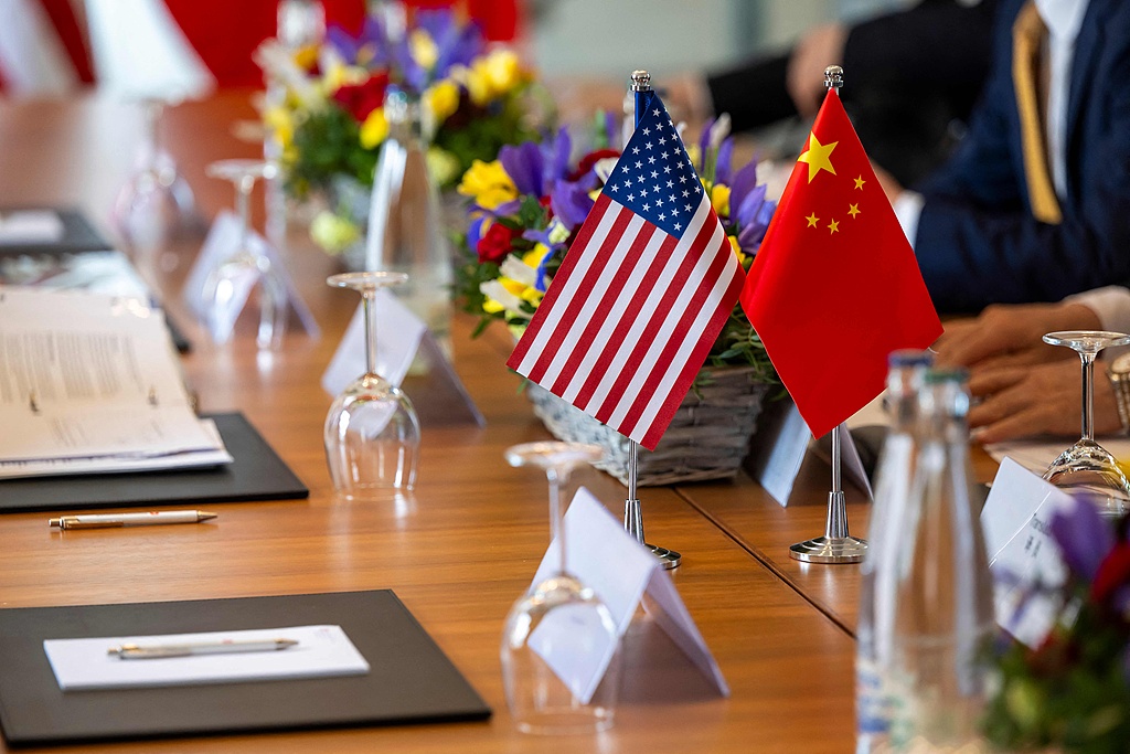 US and Chinese flags on a table