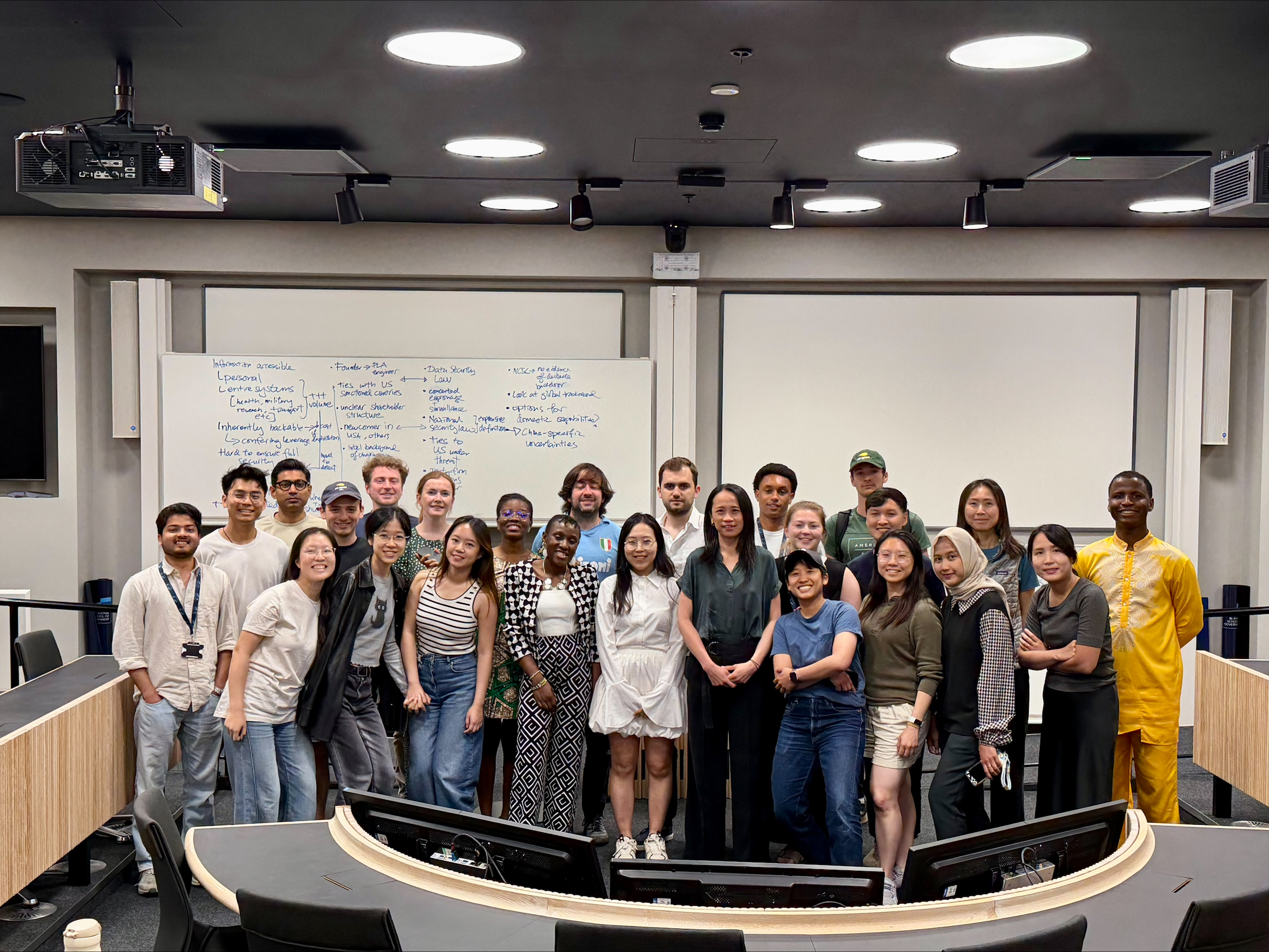MPP students stand in a lecture theatre smiling