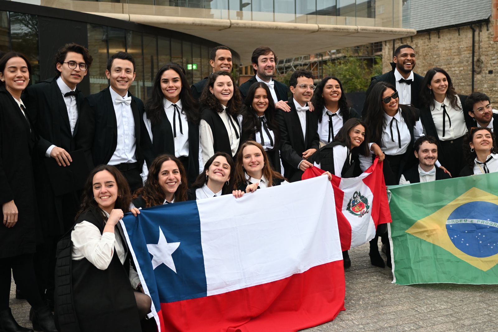 MPP scholars pose in front of building with country flags