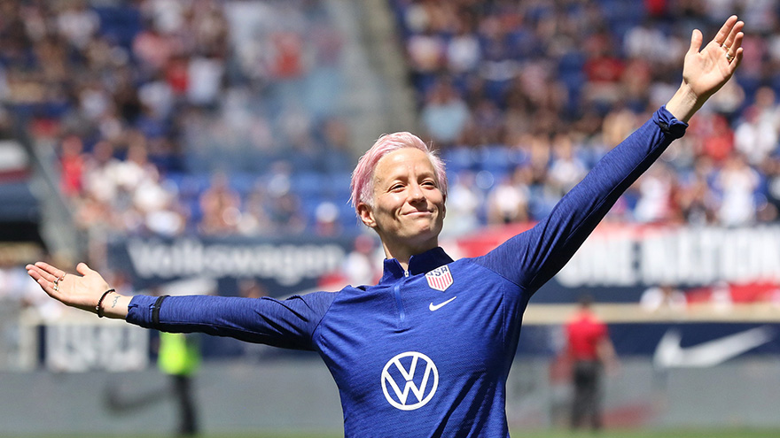 Megan Rapinoe with her arms outstretched