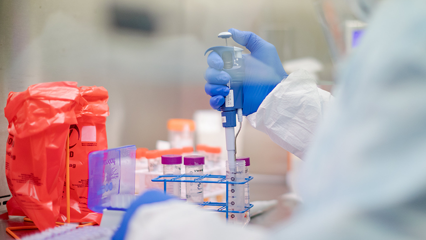 A microbiologist performing manual extraction of the coronavirus inside the extraction lab at the Pennsylvania Department of Health Bureau of Laboratories