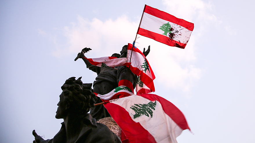Lebanese flags draped across a statue