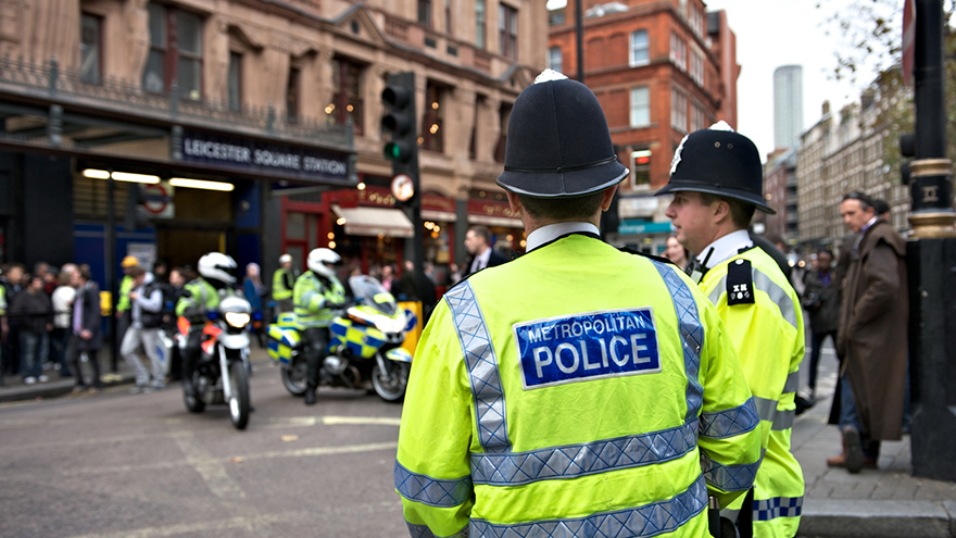 Two London policemen standing by the roadside