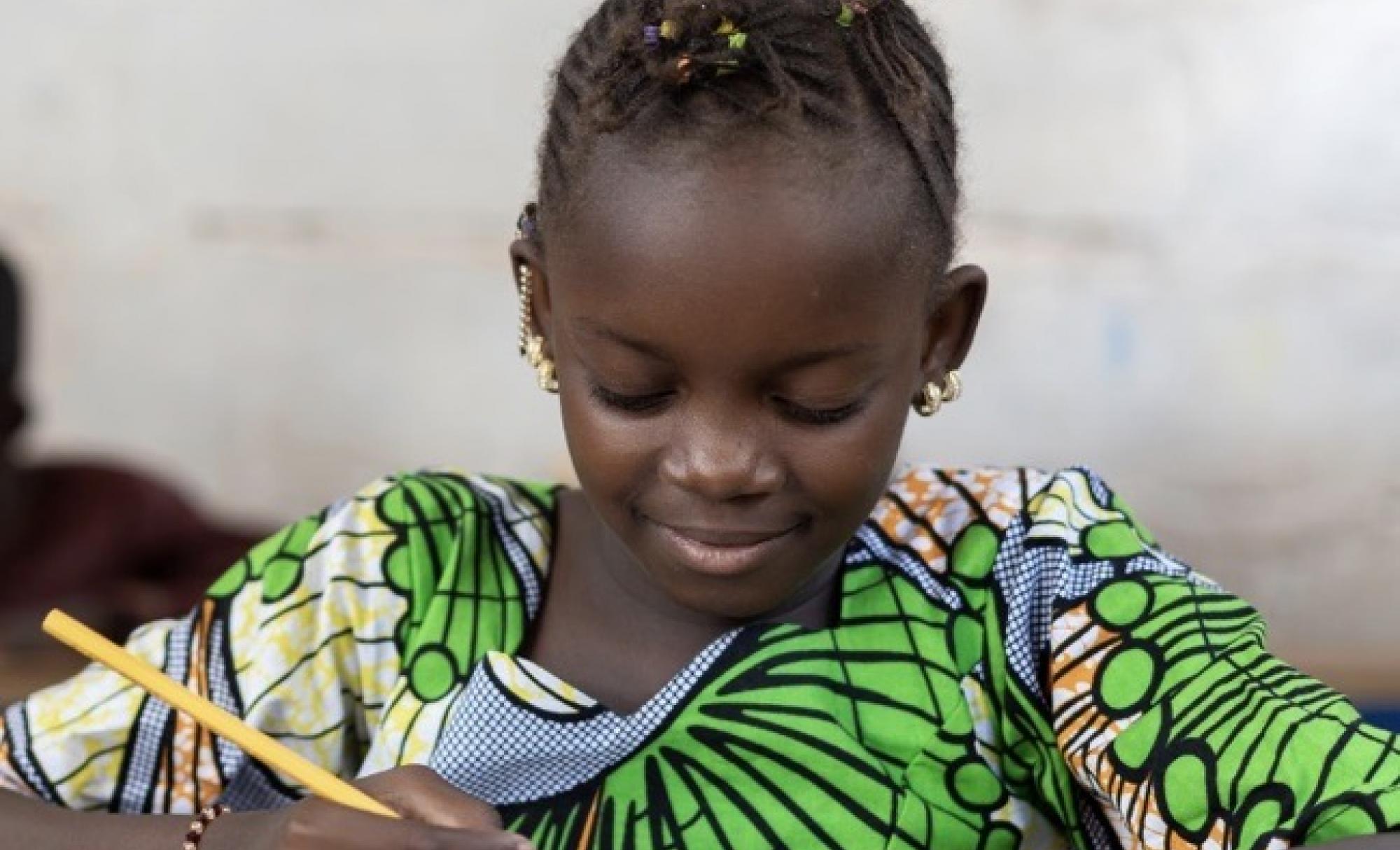 Girl writing with pencil