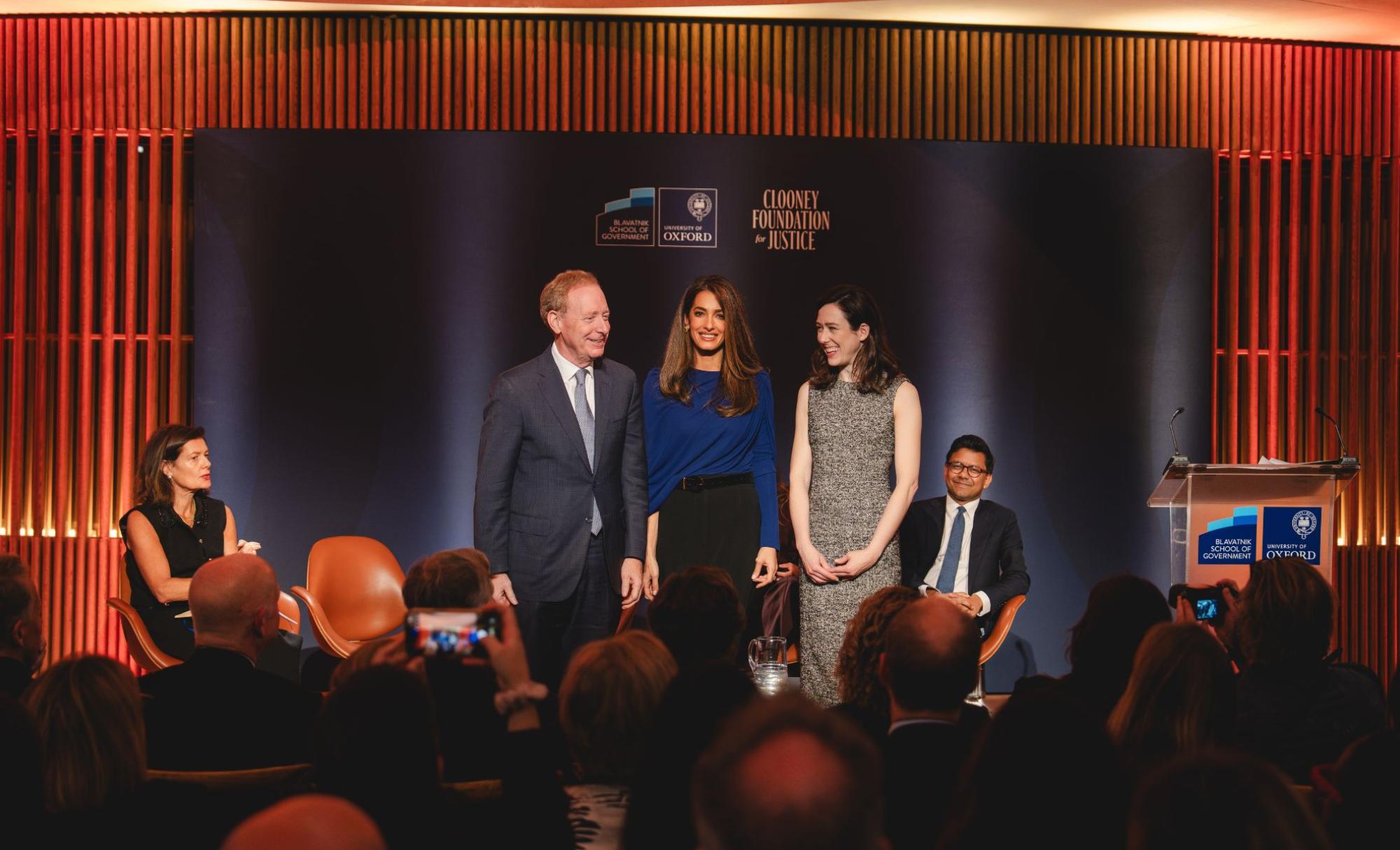 OITJ forum, Brad Smith, Amal Clooney and Elizabeth (Antrhopic) stand on stage