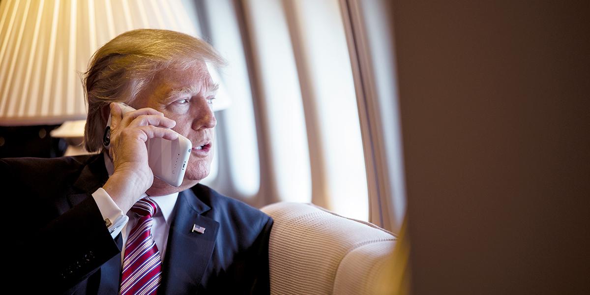 President Trump talking on a phone aboard Airforce One
