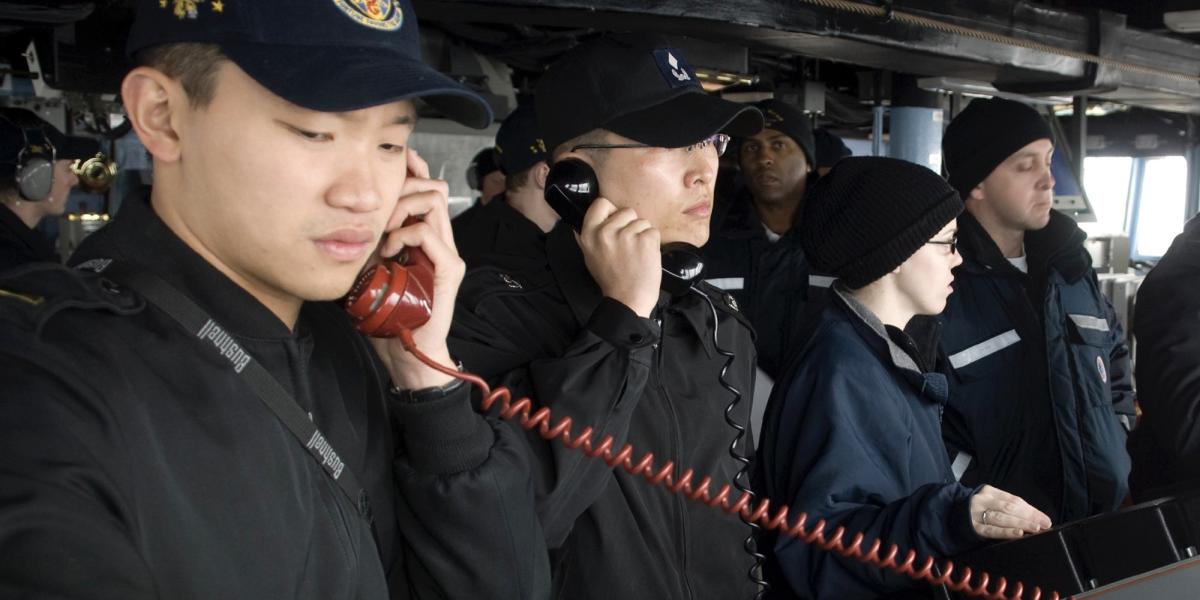PACIFIC OCEAN (March 18, 2009) Ensign Allan Aw and Republic of Korea Navy Ensign Do-Hee Jung conduct communications between the guided-missile destroyer USS John S. McCain (DDG 56) and the Republic of Korea Navy oiler Hwachon (AOE 59) during an underway replenishment. McCain, one of seven Arleigh Burke-class destroyers assigned to Destroyer Squadron (DESRON) 15, is underway supporting Exercise Foal Eagle 09, a joint exercise between the U.S. and Republic of Korea naval services. (U.S. Navy photo)