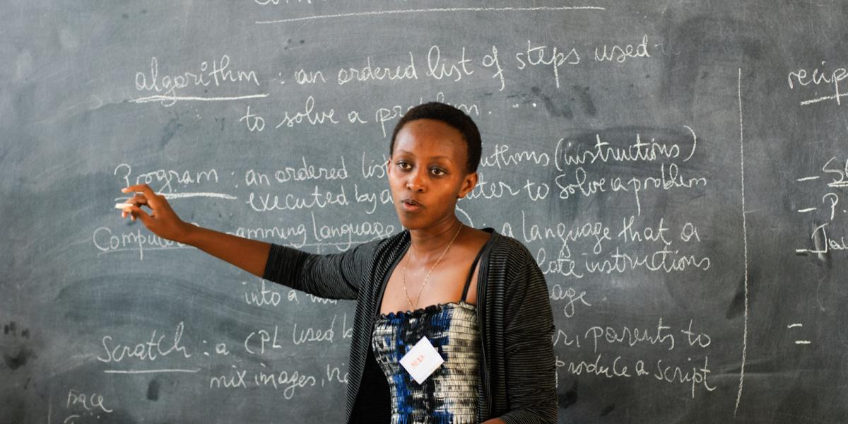 A teacher in front of a blackboard in Rwanda