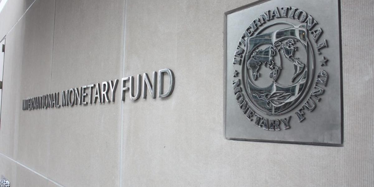 IMF headquarters in Washington, D.C., a large curved glass-and-stone building representing international financial governance