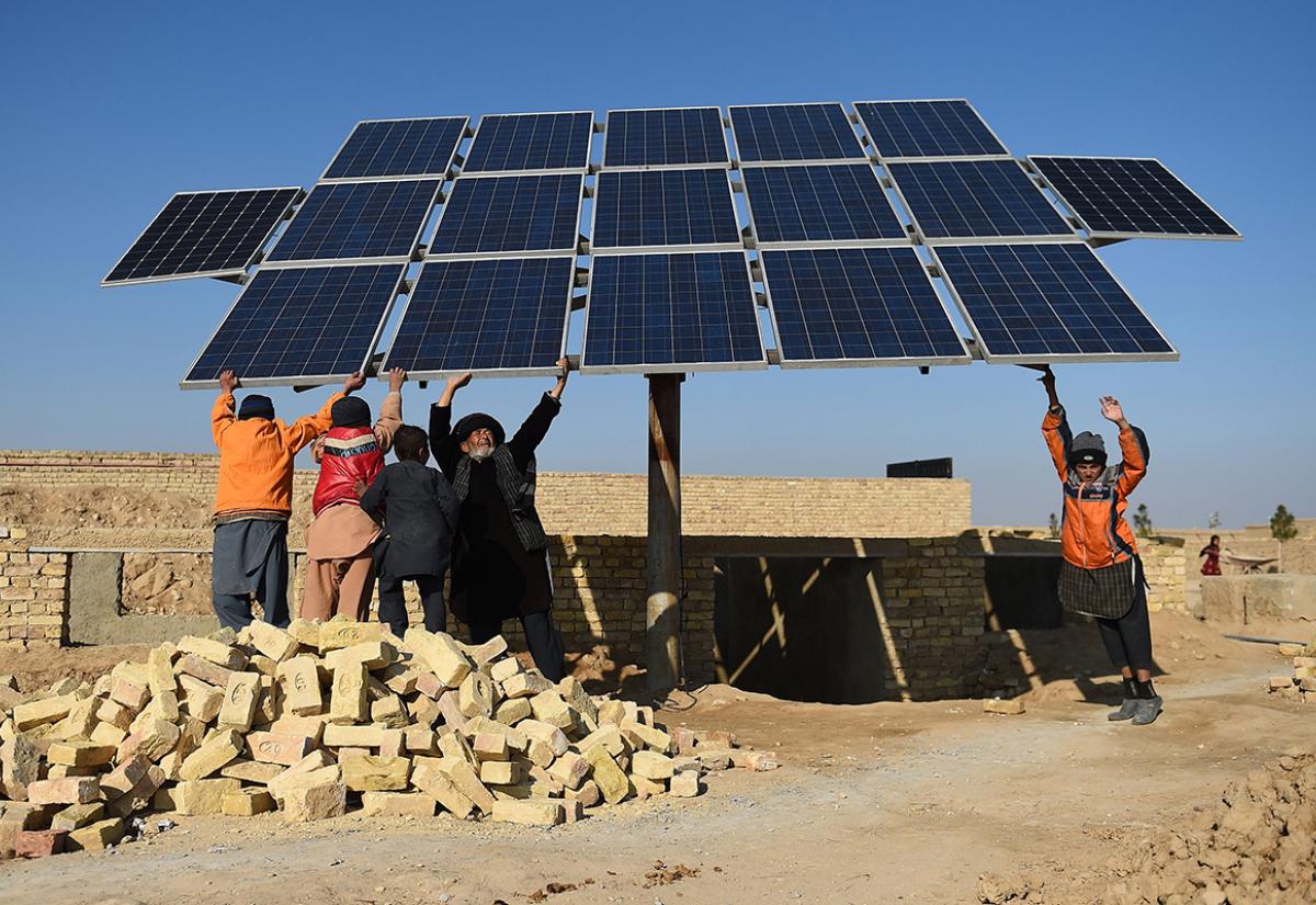 People holding solar panels 