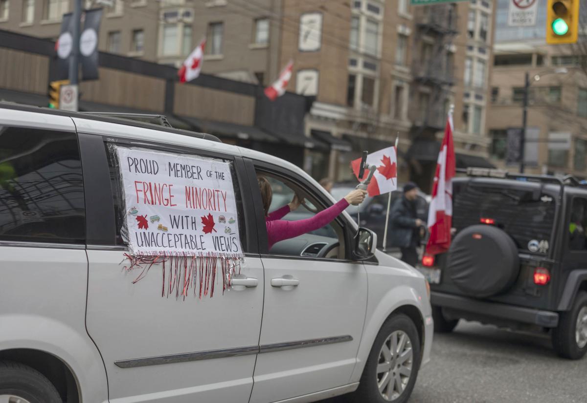 Protesters in Canada - a sign on the side of a car says "proud members of the fringe minority"