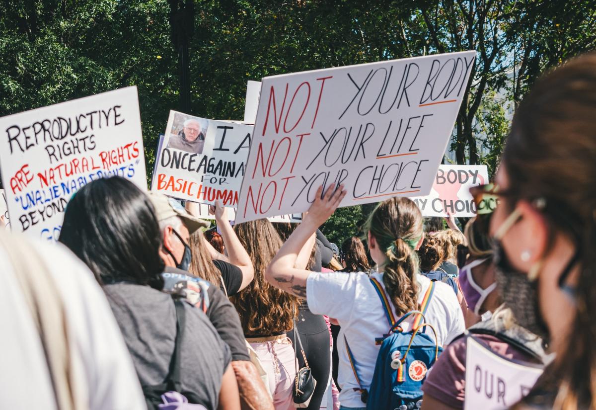 Women holding pro-choice signs at an abortion protest