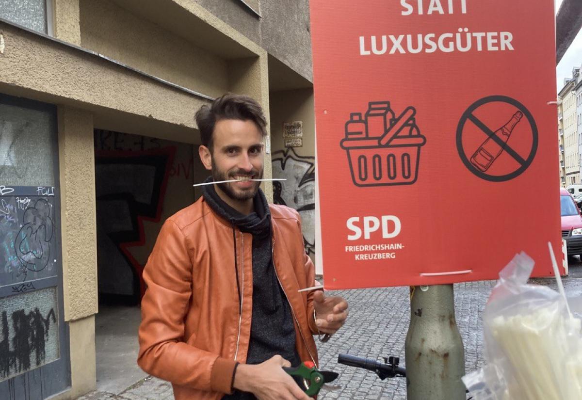 Vincent Wolff stands with SPD election campaign poster