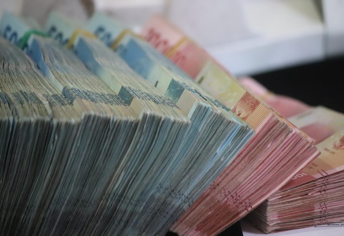 Wads of cash. Photo by Mufid Majnun on Unsplash