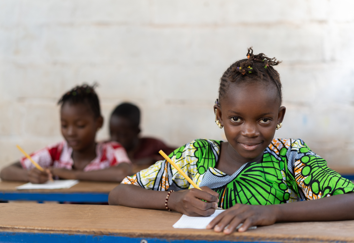 Girl in bright top in classroom in Africa