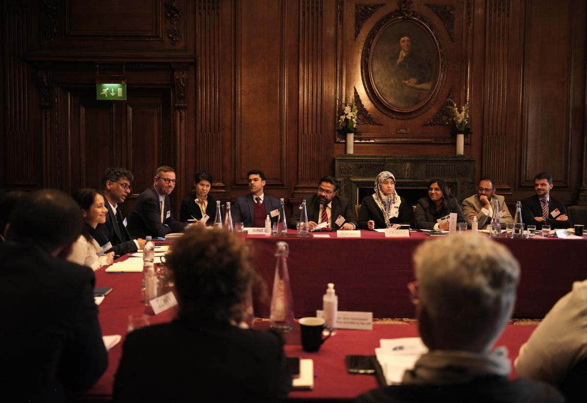 Participants at table speaking 