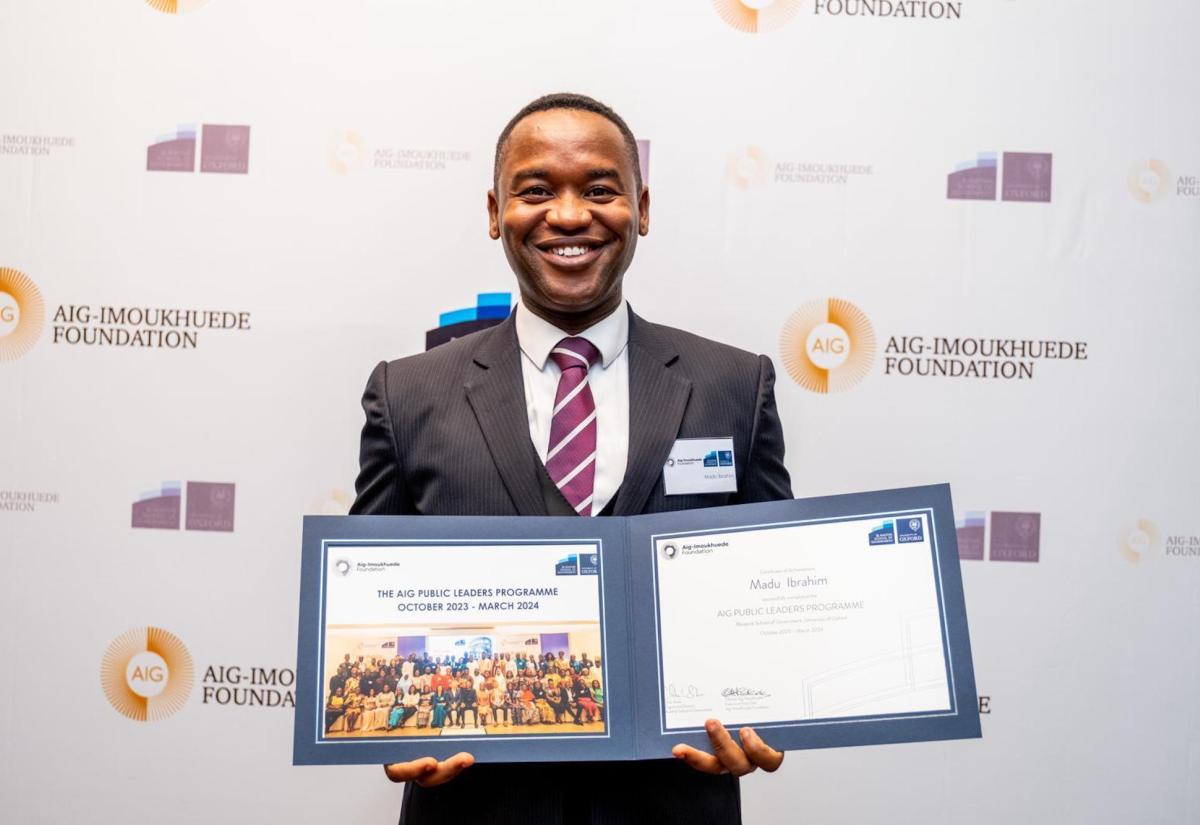 Madu Ibrahim with his AIG certificate