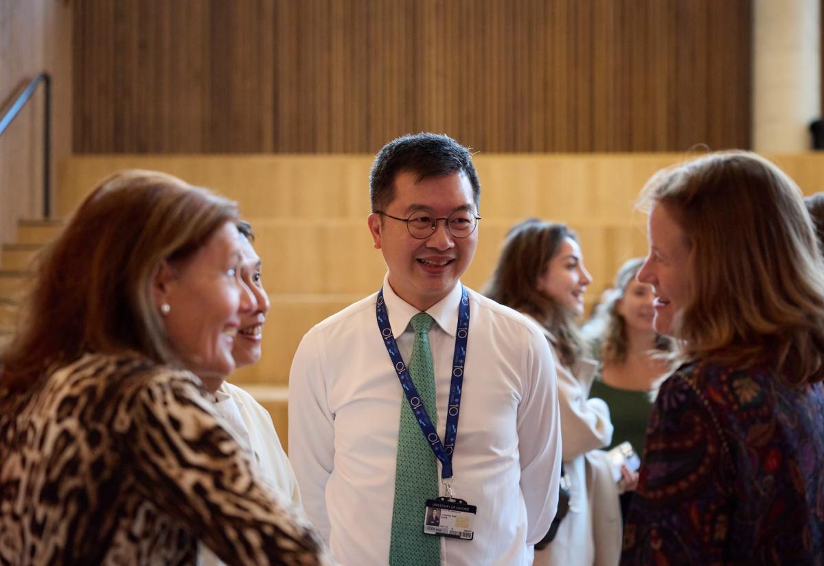 Staff member Jackie Liu talking to students