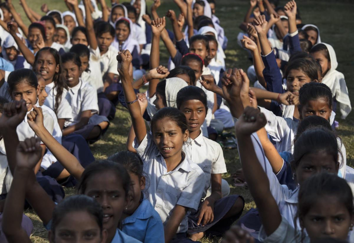 Girls raising their hand in class