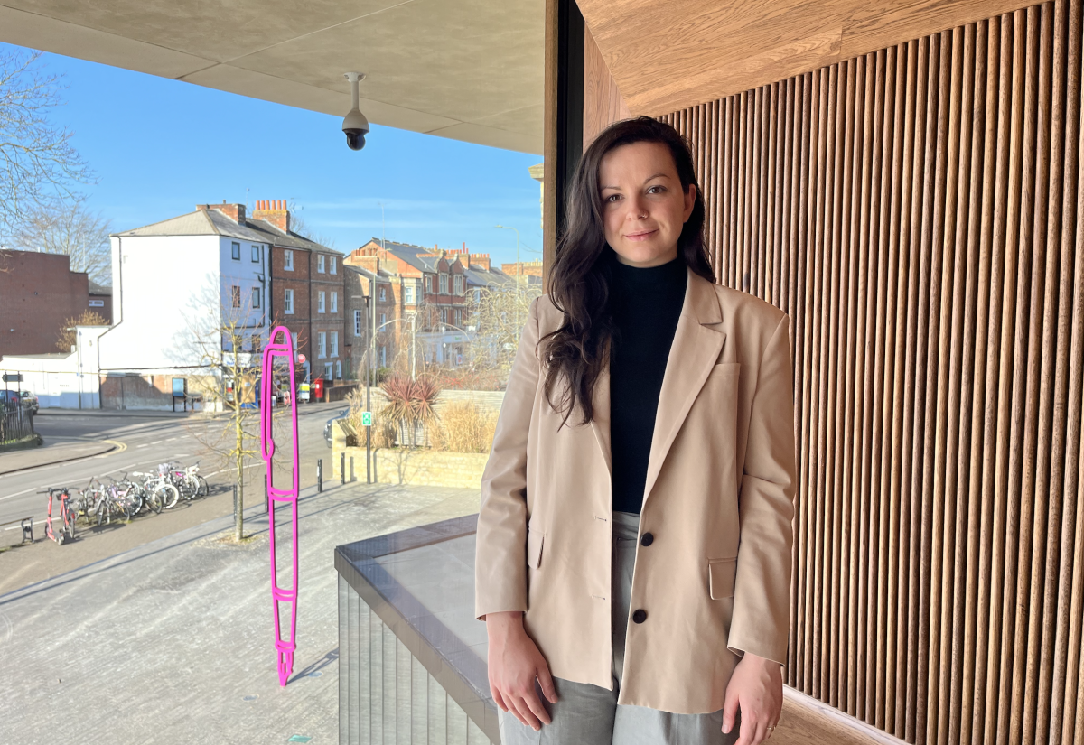 Image of MPP student, Emma, in front of the window to the world at the Blavatnik School