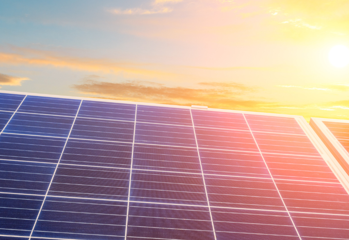 Solar panels against a sunset