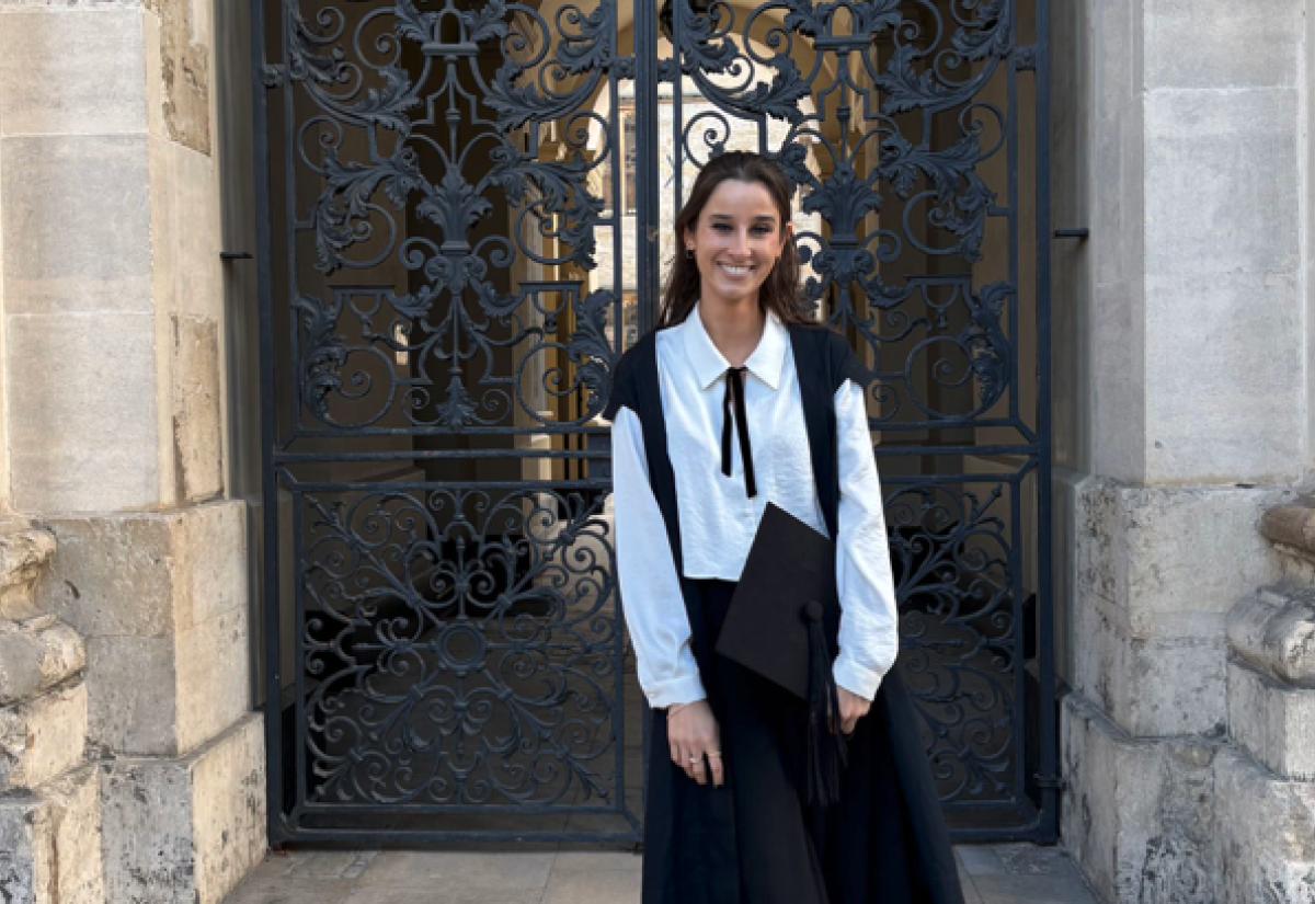 Chanel Contos in front of an ornate gate