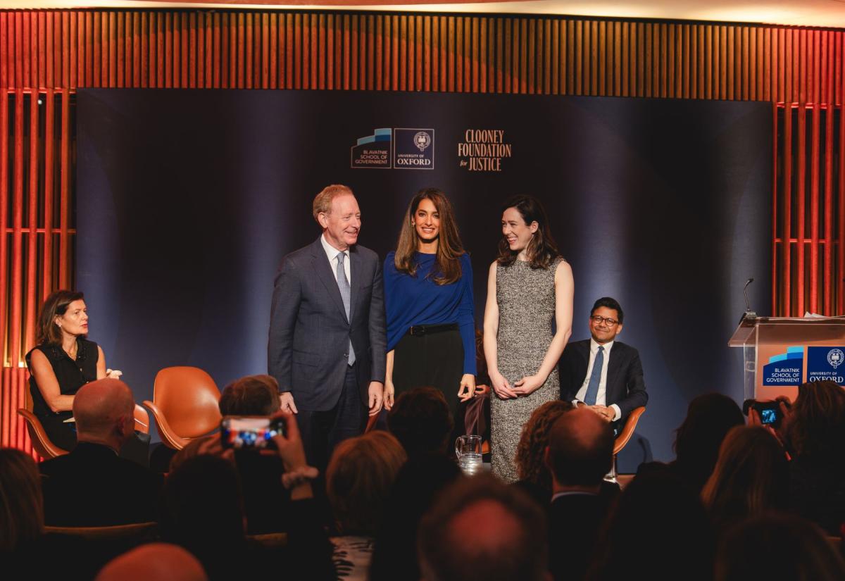 OITJ forum, Brad Smith, Amal Clooney and Elizabeth (Antrhopic) stand on stage