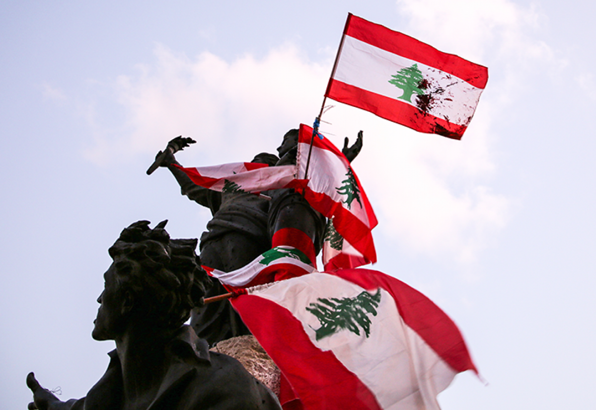 Lebanese flags draped across a statue