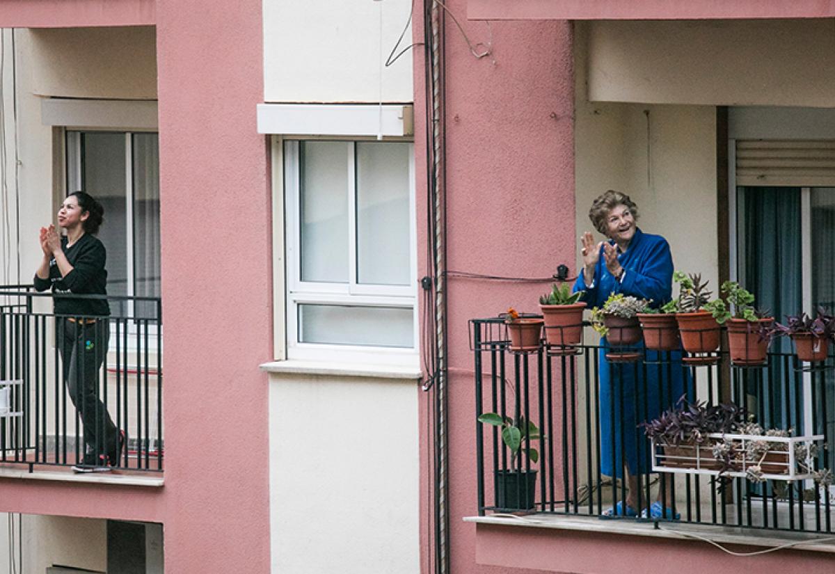 People clapping from balconies during lockdown