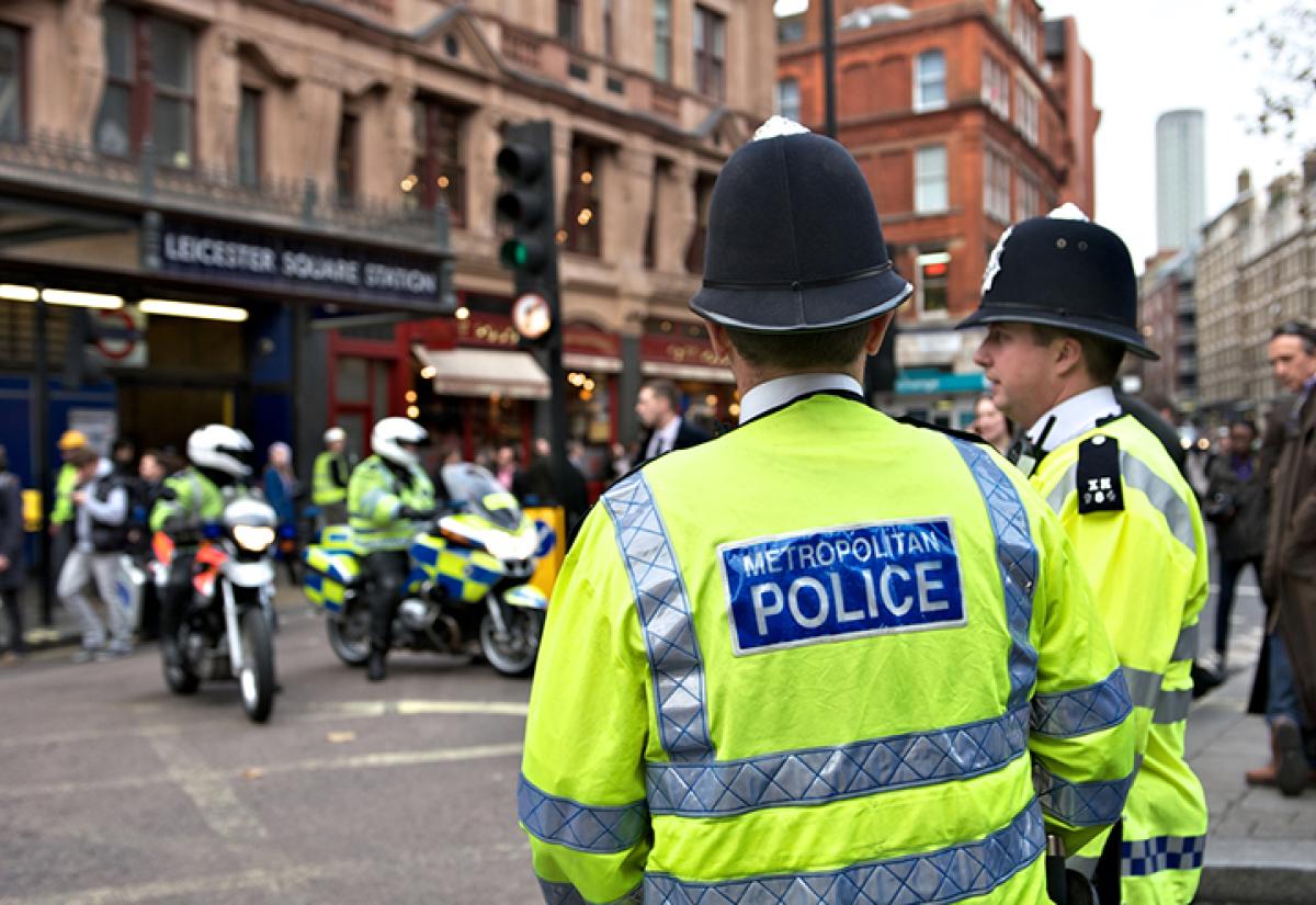 Two London policemen standing by the roadside