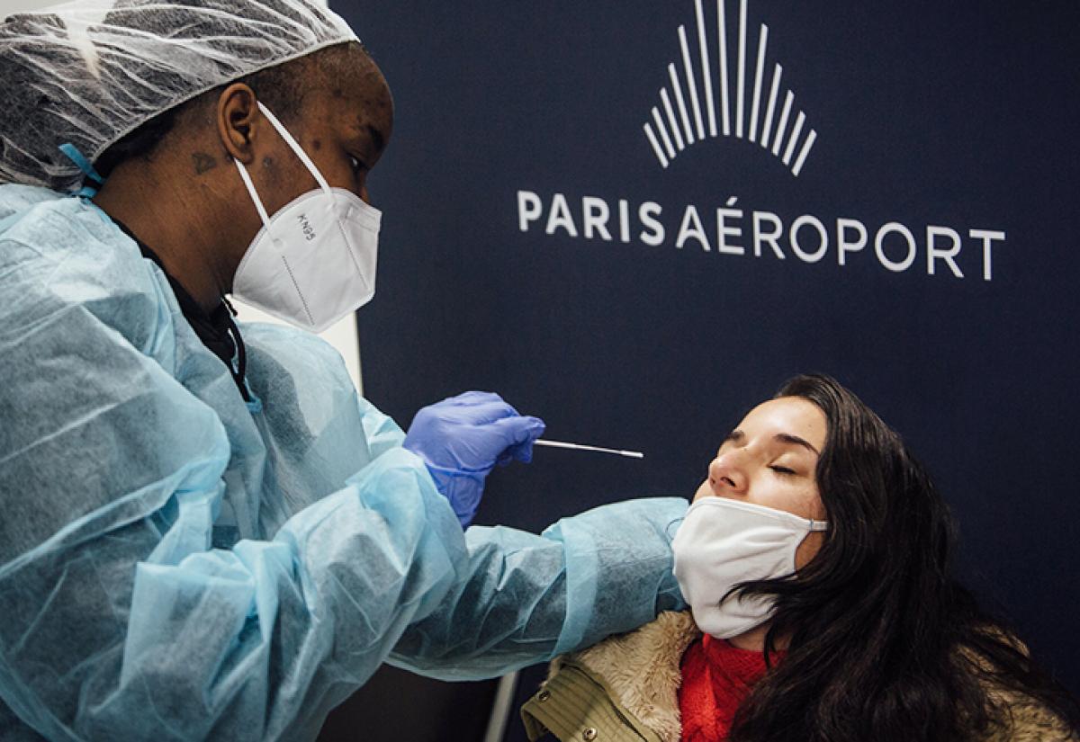 A passenger is tested for COVID-19 at Roissy Charles de Gaulle International Airport