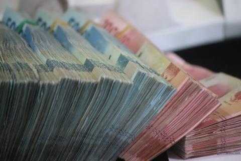 Wads of cash. Photo by Mufid Majnun on Unsplash