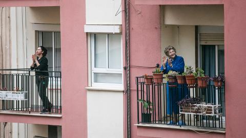 People clapping from balconies during lockdown