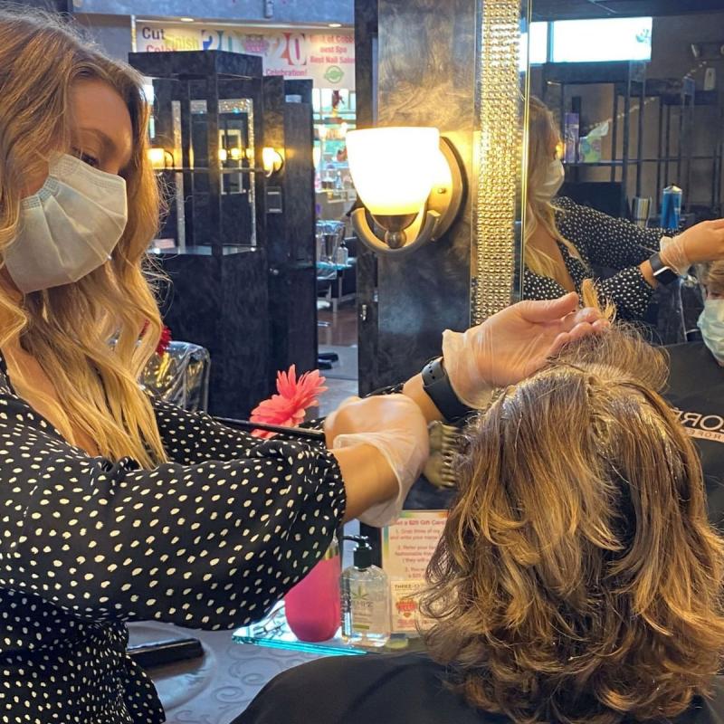 Some jobs, such as hairdressing, simply cannot be done while observing social distancing measures CREDIT: RICH MCKAY /REUTERS