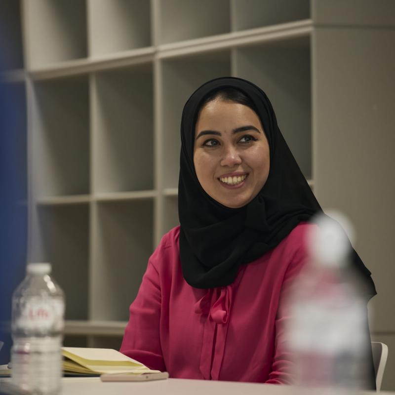 Rising Public Leader Programme participant wearing a hijab smiles during a tutorial