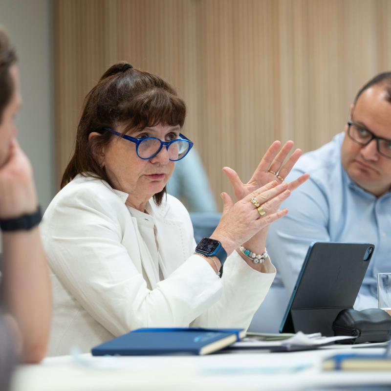 Female Executive Public Leaders Programme participant talks during class while male peer listens