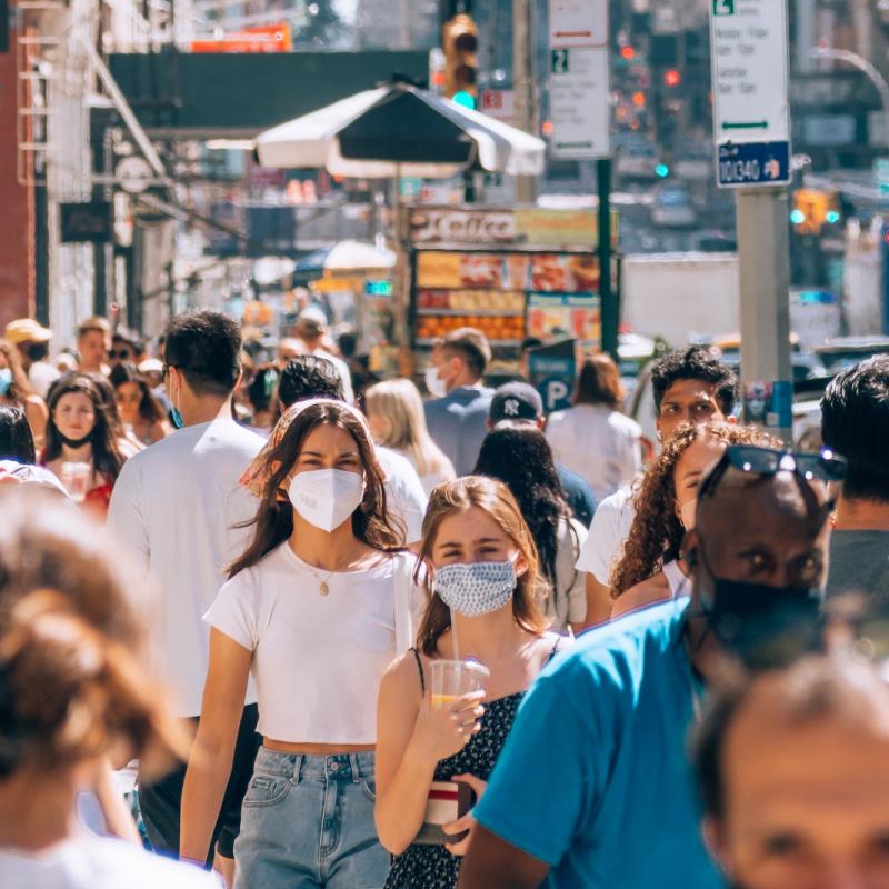 Two women in a crowd with face masks