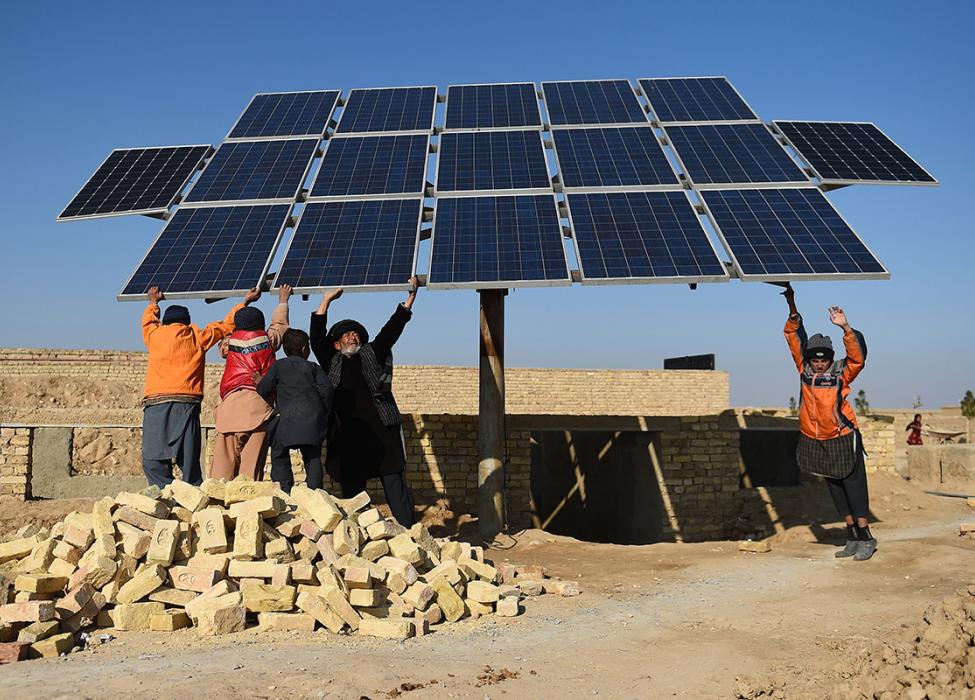 People holding solar panels 