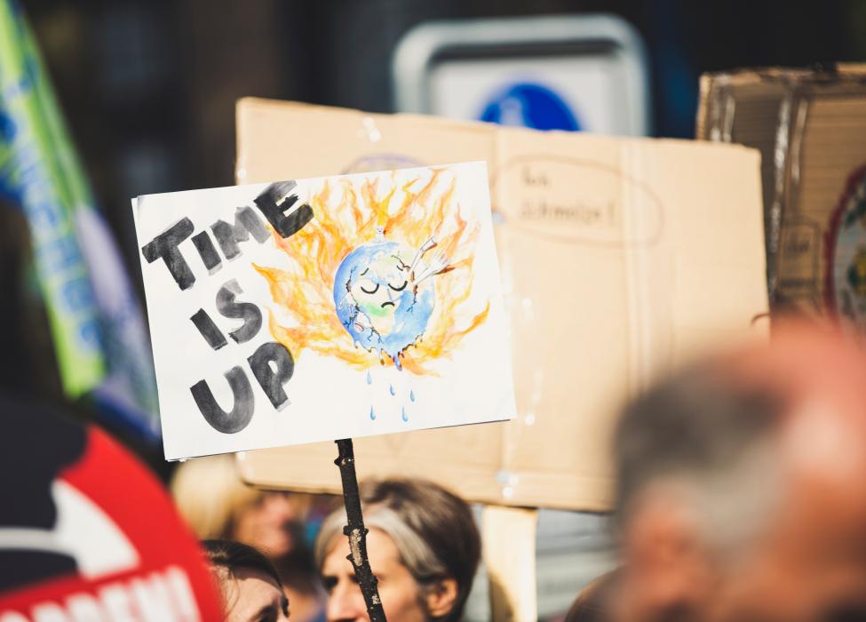 Poster saying "time is up" during a climate change protest